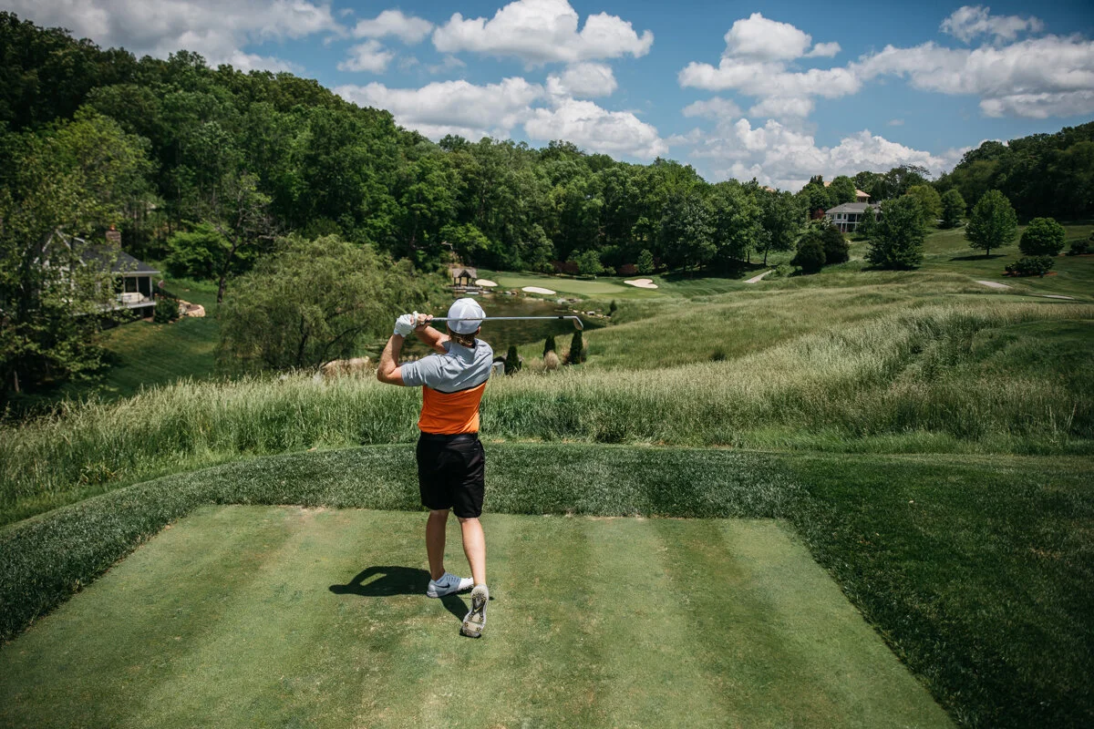 A golfer on the opening tee, the Highlands beyond