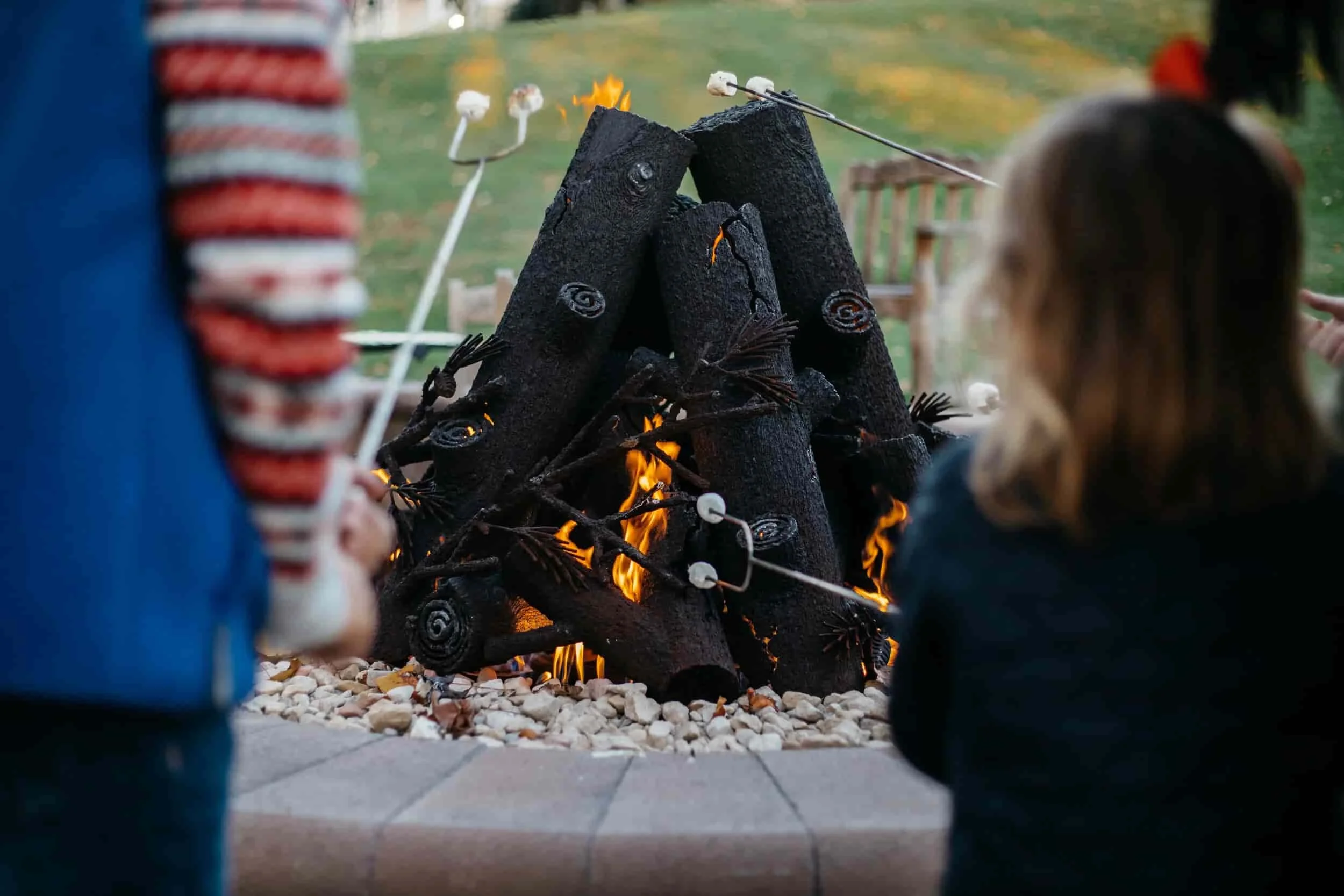 Children at the fire pit on the clubhouse lawn